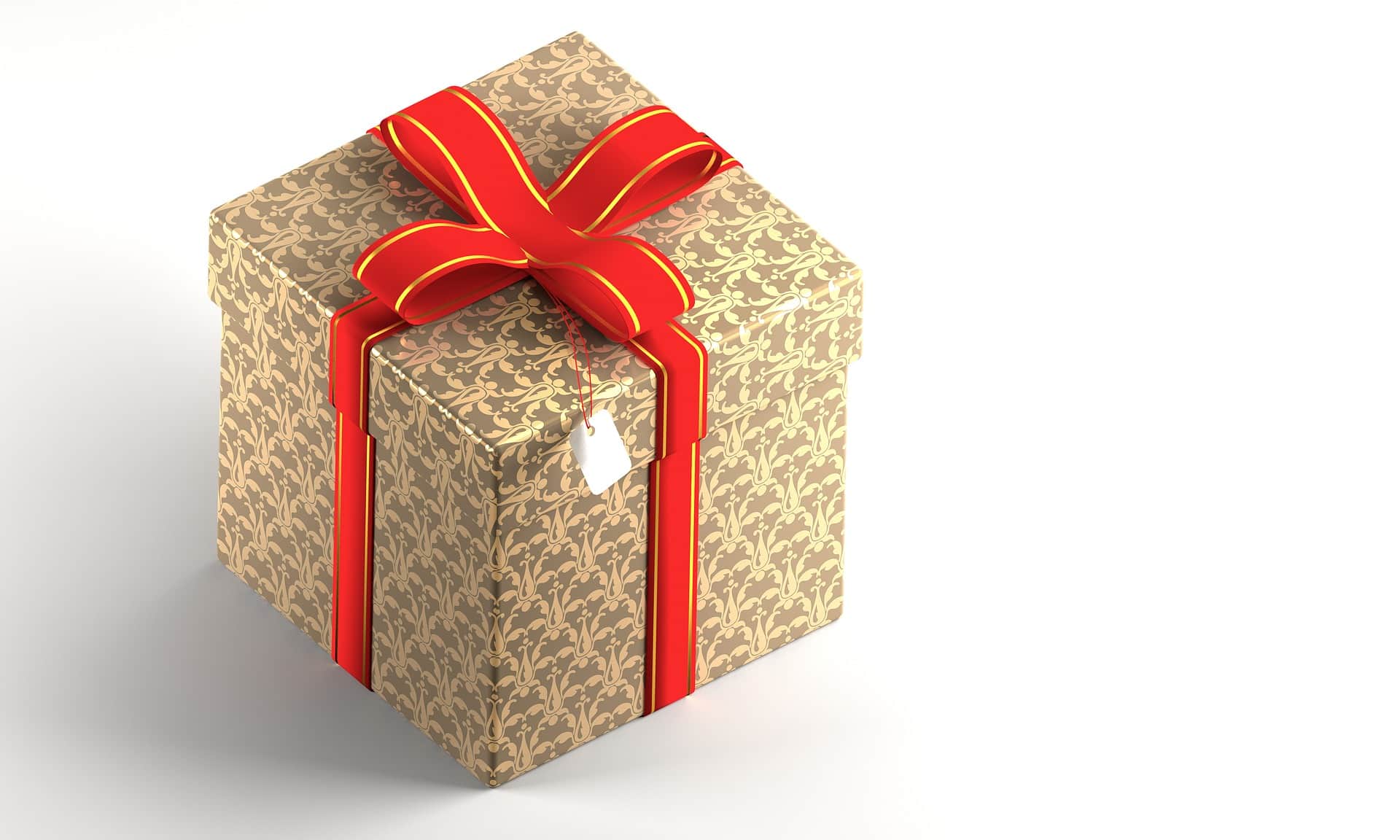 Gift box with ornate gold design and red ribbon, symbolizing holiday shopping and in-store retail experiences.