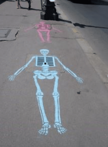 Colorful chalk drawings of skeletons on a sidewalk, illustrating bold guerilla marketing techniques in urban advertising.