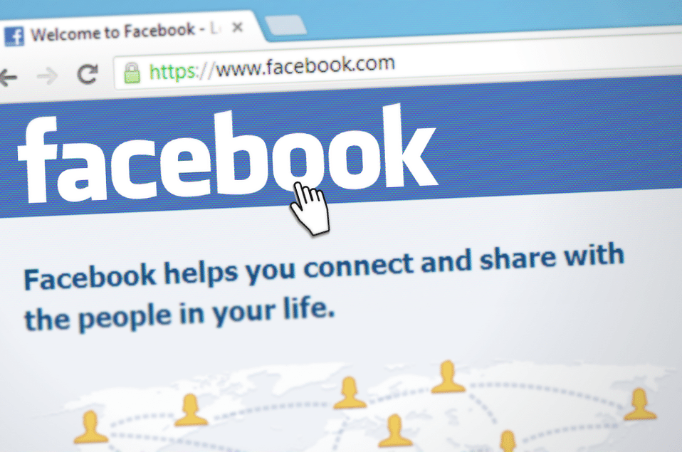 Facebook homepage displaying the logo and tagline, with a cursor hovering over the 'Facebook' link, emphasizing social media connectivity and engagement.