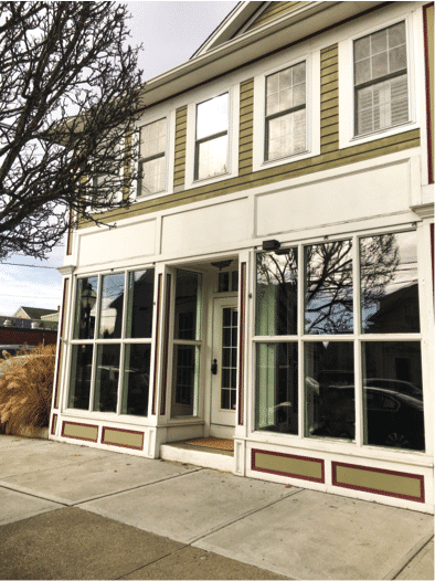 New office building of PMC Media Group in East Greenwich, RI, featuring large windows and a welcoming entrance, reflecting the company's recent relocation.